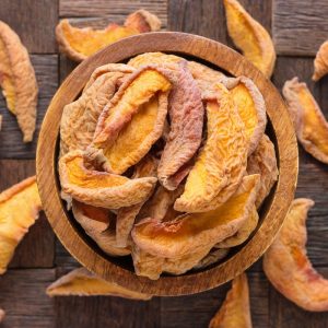 dried peaches in wooden bowl